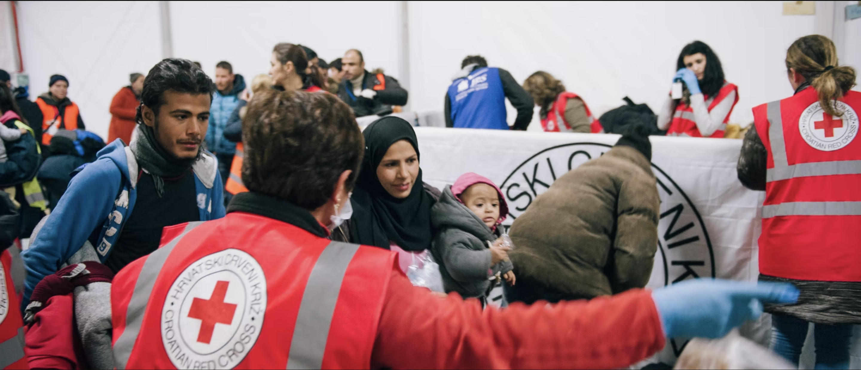 Red Cross Staff guide people.